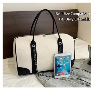 Large canvas tote bag size comparison with iPad and laptop on a bed setting