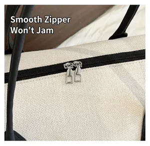 Detail of smooth silver dual metal zippers on high-quality contrast canvas travel tote bag