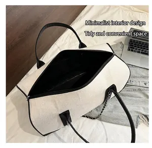 Detail of spacious canvas tote interior with black lining and sturdy contrast straps