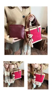 Detail of red wool tote bag with lamb fleece trim, red leather handles and bear charm