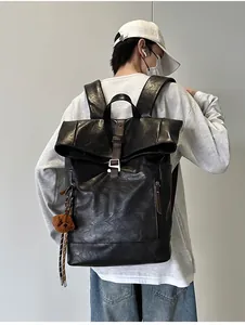 Male model showing a large capacity black PU leather backpack with brown buckle straps