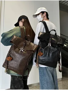 Detail of vintage PU leather backpacks with lychee texture and metal buckle flap cover