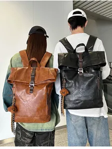 Detail view of large capacity waterproof PU leather backpacks in brown and black with bear charm