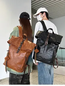 Waterproof laptop backpack shown in black and brown leather texture with plush bear charm
