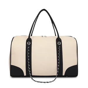 Large contrast canvas travel tote with black leather trim and silver chain decor