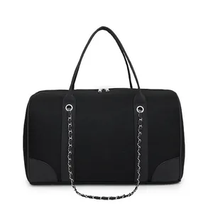 Detailed macro view of black mesh fabric handbag with silver chain strap and leather trim
