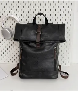 Detail of waterproof black faux leather backpack with brown straps and buckle closure