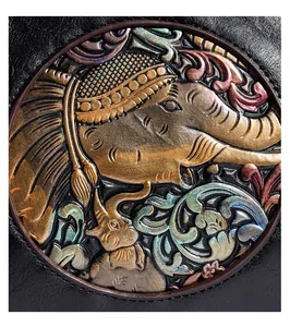 Close-up of embossed elephant pattern with metallic finish on black lychee grain leather