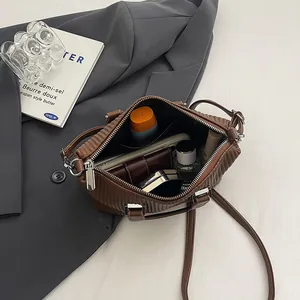 Vertical pleated dark brown crossbody bag with interior storage for daily essentials