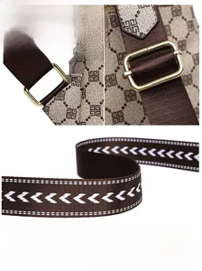 Close-up of golden metal hardware and white wave embroidery on the vintage backpack strap