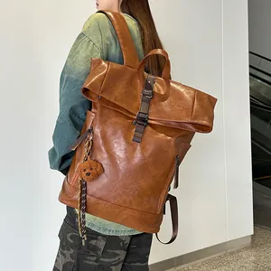 Retro brown large capacity waterproof backpack with doll charm on a male model