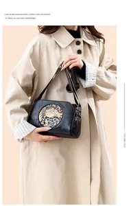 Detail of vintage pillow bag featuring ethnic elephant pattern and wide woven strap