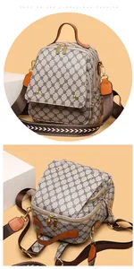 Macro detail of retro pattern backpack with gold hardware and wide shoulder strap