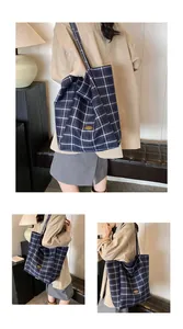 Detail of the navy blue checkered canvas tote bag showing the soft texture and large capacity