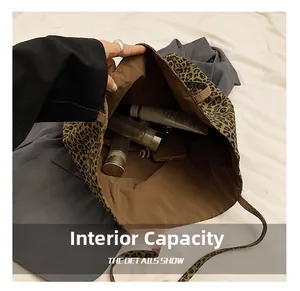 Internal capacity of the leopard print tote bag showing storage space for phone and makeup