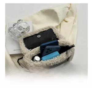 Internal view of the plush shoulder bag showing storage space for phone and makeup