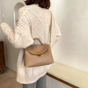 Fashionable latte-colored crossbody bag with gold buckle and adjustable strap for women