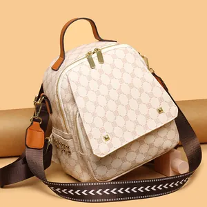 Retro print small backpack in cream leather with brown trim and woven shoulder strap