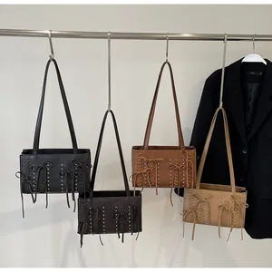Detail of vintage suede shoulder bags with bow accents and woven drawstring in four colors
