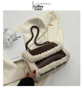 Detail of coffee brown shoulder bag with white faux shearling trim and metal chain strap