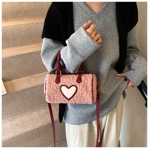 Detail van roze pluche Boston tas met zachte faux fur textuur en witte hartvormige patch