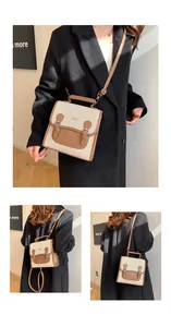 Detail view of contrast canvas and leather backpack with decorative metal bow