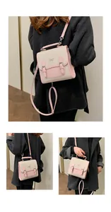 Detail of canvas mini backpack with pink leather flap and silver bow accent