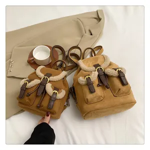 Detailed comparison of two plush brown backpacks in small and mini sizes with faux fur trim