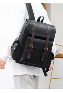Detail of black leather backpack featuring pebbled texture and vintage buckle closure