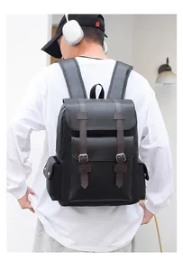Close-up of black 15 inch leather backpack featuring silver buckles and brown straps