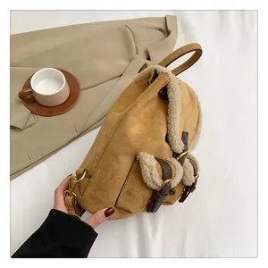 Detailed close-up of camel plush backpack with shearling trim and brown leather straps