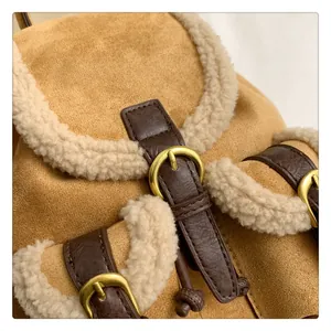 Macro detail of brown suede and white faux shearling trim on a retro winter backpack