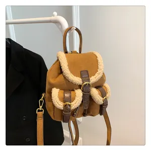 Detail of plush brown suede mini backpack with fleece trim and vintage metal buckles