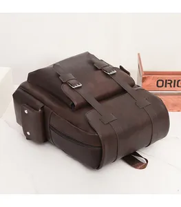 Detail view of dark brown vintage faux leather backpack showing magnetic buckle strap texture