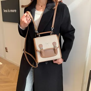 Vintage contrast color canvas and leather backpack with a bow buckle and top handle