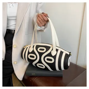 Close-up of contrast stripe bucket bag with lychee texture and round cylinder design