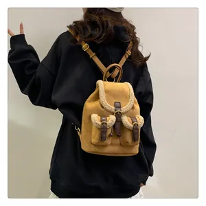 Brown faux suede backpack with beige plush shearling trim detail in a vintage style