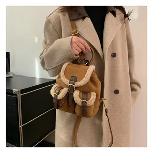 Detail of plush winter backpack featuring brown suede and white faux fur trim details