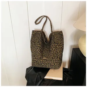 Detail of canvas leopard print tote bag featuring a handmade label and spacious interior