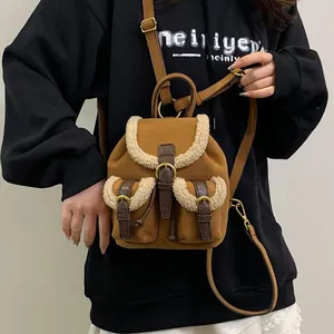 Winter plush brown suede backpack with faux fur trim and gold buckle front pockets