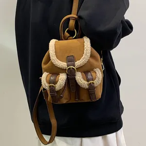 Winter plush brown suede backpack with white faux shearling trim and metal buckle