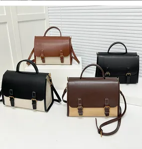 Detailed shot of retro messenger bags showing leather stitching and metal buckle accents