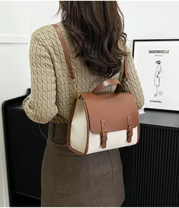 Chic retro two-tone canvas and leather backpack shown on model in a stylish interior