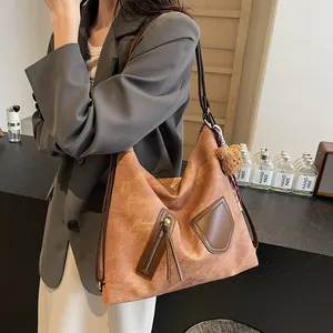 Retro brown leather tote bag with plush bear charm and vintage aesthetic design