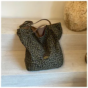 Detailed view of the handmade metal plaque and green leopard print fabric texture