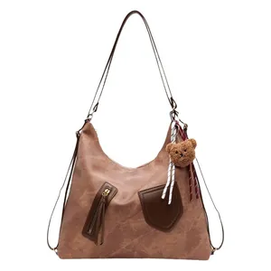 Retro dark brown large capacity crossbody tote bag with bear charm on white background