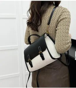 Detail of a vintage retro messenger backpack featuring bicolor canvas and black leather accents