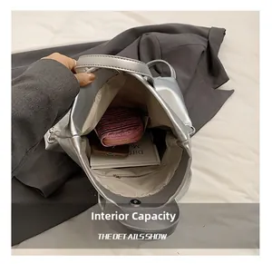 Internal capacity of silver metallic backpack showing space for wallet, phone and books