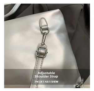 Close-up of adjustable metallic silver shoulder strap with durable metal buckles