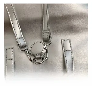 Detail of premium silver metal lobster clasp and D-ring on the matte silver backpack
